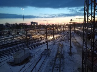 Naklejka na ściany i meble railway station from above at dawn with blue clouds