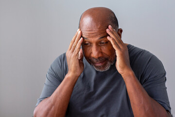 Older man not feeling well and having a headache.