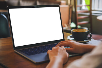 Mockup image of a woman using and typing on laptop computer with blank white desktop screen in cafe