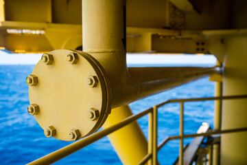 Male worker inspection at steel long pipes and pipe elbow in station oil factory during refinery valve of visual check record pipeline oil and gas industry.