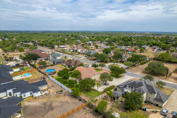 Aerial drone view of American suburban neighborhood. Establishing shot of America's suburb. Residential single family houses pattern.