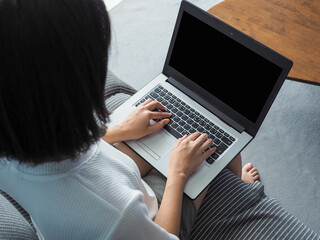 business woman using laptop, black screen background