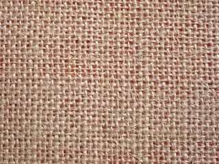 Jute fabric with pink undertone close-up as background
