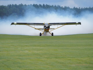 Airplane on the airport with smoke in the background