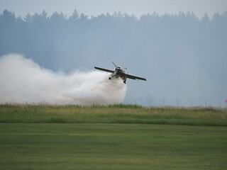 Airplane with smoke in the background