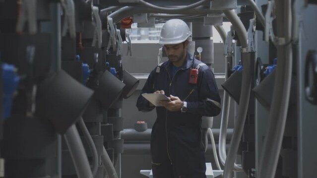 Engineer under checking the industry chilled water fan coil unit air conditioner is water cooling tower air chiller HVAC system of large industrial building to control air system 