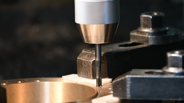 The close-up scene tapping process on NC milling machine.