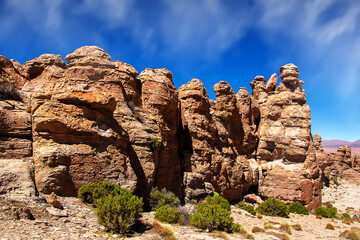 Carved red rocks in rocky desert. Marvelous stones formation. Natural background