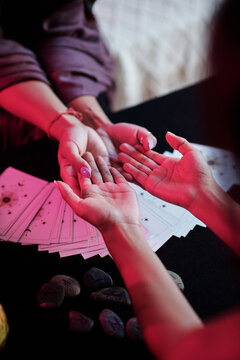 Sorceress reading palm lines for client to tell fortune and predict future life
