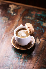 Cup of coffee and Cantuccini (Italian cookie) on rustic wooden background. Copy space.