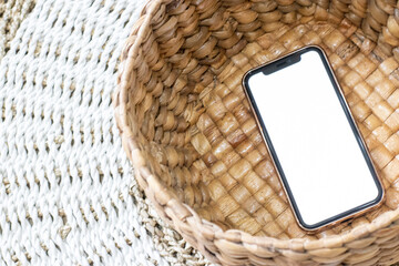 Smartphone mockup placed on a basket with blank white image