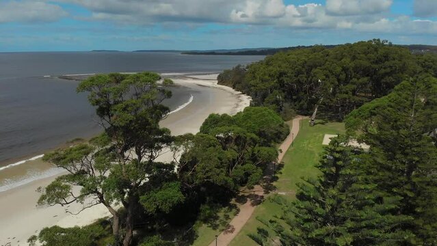 Drone video of Moona Moona Creek and Huskisson beach area after recent flooding with brown dirty water flowing into the bay