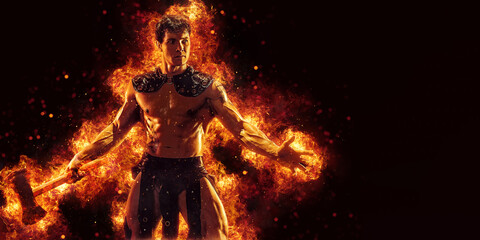 Portrait of burning barbarian with naked torso who posing holding axe in dark studio background