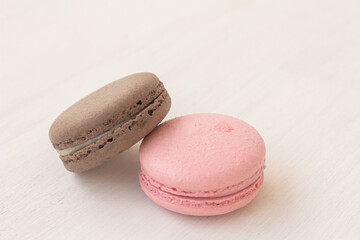 White macaroon and pink macaroon on white background. Traditional French dessert for coffee. High quality photo