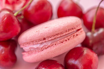 Obraz na płótnie Canvas Pink macaron with fresh berries on pink background. Berry dessert