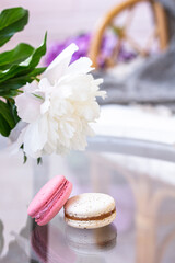 Summer vibes – summer dessert on a glass table, macarons, white flower.  Copy space
