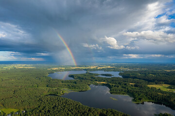 Aerial summer beautiful view of rainbow over the forest and lake, Lithuania