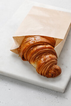 Croissant in a paper bag mock up, take away food. Brown envelope paper for food. Copy space for text.