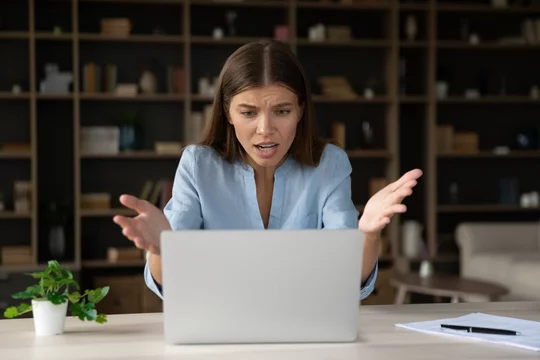 Annoyed stressed businesswoman having problem with laptop, broken or discharged device. Office employee looks at screen, read awful news feels shocked, unexpected app crash, unsaved data, spam concept