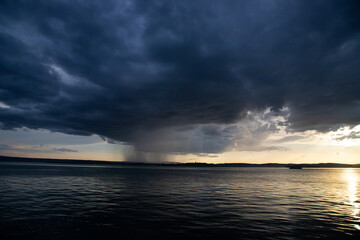 Naklejka na ściany i meble Heavy dark fast moving thunderstorm clouds over lake Constance, Germany
