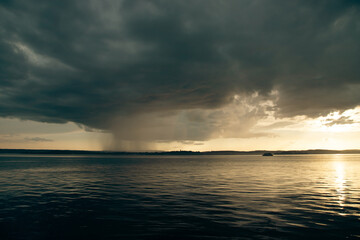 Heavy dark fast moving thunderstorm clouds over lake Constance, Germany