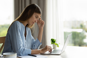 Woman faced up with problem, lack of understanding of task, read unpleasant email get notification with bad news feel frustrated sit at desk with laptop. Issue, dismissal, professional failure concept