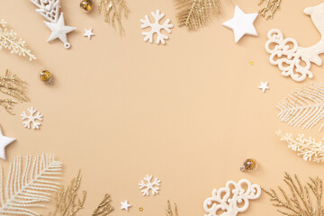 Festive Christmas and New Year backround with golden white holiday decoration on pastel beige background. Top view. Merry Christmas monochrome concept