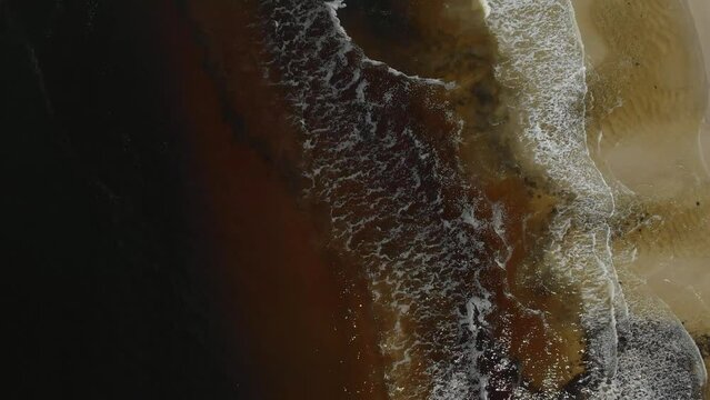 Drone video of Moona Moona Creek and Huskisson beach area after recent flooding with brown dirty water flowing into the bay