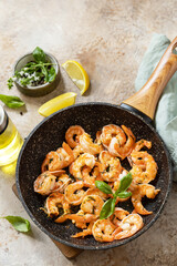 Spicy garlic chili Shrimps boiled shrimps and herbs, prawns in a frying pan with lemon. Seafood, shellfish. Copy space.