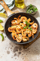 Spicy garlic chili Shrimps boiled shrimps and herbs, prawns in a frying pan with lemon. Seafood, shellfish. Copy space.