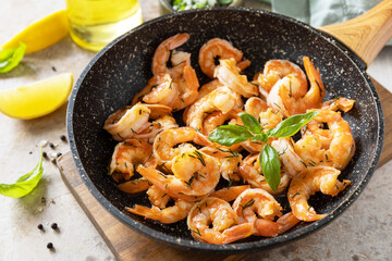 Spicy garlic chili Shrimps boiled shrimps and herbs, prawns in a frying pan with lemon. Seafood, shellfish.