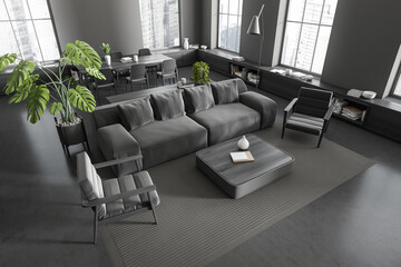 Corner view on dark studio room interior with sofa, table