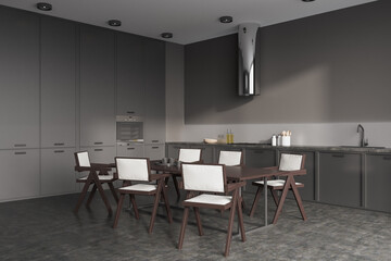 Grey kitchen interior with eating table and chairs, kitchenware