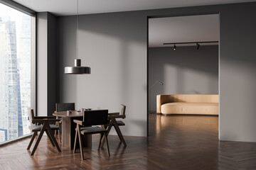 Grey dining room interior with table and seats, panoramic window