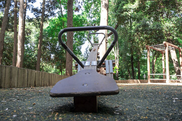 Wooden seesaw in park, bottom view of kids toy in forest, rising and increasing concept, ups and...