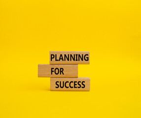 Planning for success symbol. Concept words Planning for success on wooden blocks. Beautiful yellow background. Business and Planning for success concept. Copy space