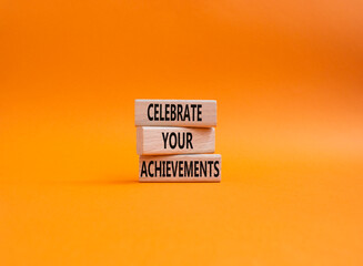 Celebrate your achievements symbol. Concept words Celebrate your achievements on wooden blocks. Beautiful orange background. Business and Celebrate your achievements concept. Copy space
