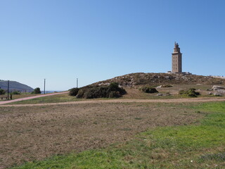 Green hill with tower of Hercules in A Coruna city at Galicia, Spain