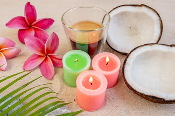 Cup Coffee and burning aroma candles on sand beach.