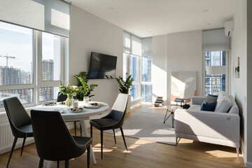 sunny modern apartment, modern living room with light walls, breakfast in the apartment