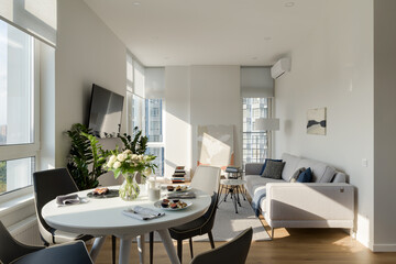sunny modern apartment, modern living room with light walls, breakfast in the apartment