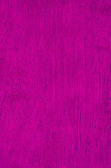 Purple painted rough wall in closeup