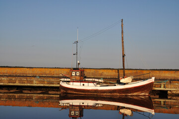 Fototapeta na wymiar Old wooden fishing boat by the pier in Gotland, Sweden.
