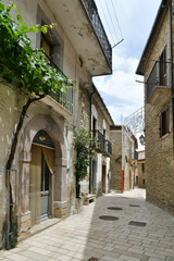 Obraz premium A narrow street between the old houses of Albano di Lucania, a village in the Basilicata region, Italy.