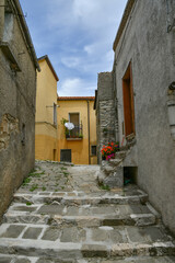 A narrow street between the old houses of Albano di Lucania, a village in the Basilicata region, Italy.