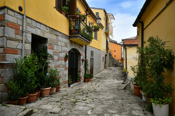A narrow street between the old houses of Albano di Lucania, a village in the Basilicata region, Italy.	