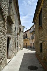 Fototapeta na wymiar A narrow street between the old houses of Albano di Lucania, a village in the Basilicata region, Italy. 
