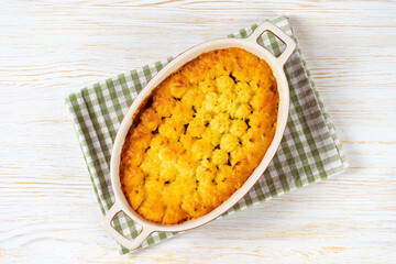 Shepherd's pie or Cottage pie. Minced meat, mashed potatoes and vegetables casserole on white wooden background. Traditonal British, United Kingdom, Ireland cuisine. Top view, flat lay