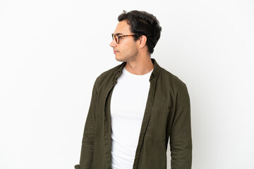 Caucasian handsome man over isolated white background looking to the side