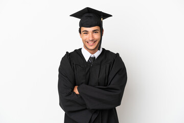 Young university graduate over isolated white background keeping the arms crossed in frontal...
